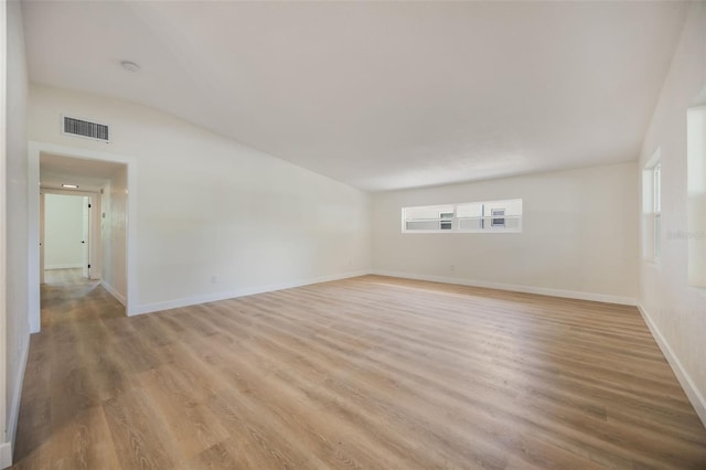 3813 Surrey Dr, Orlando, FL 32812 - unfurnished room with light wood-type flooring, vaulted ceiling, plenty of natural light, and baseboards