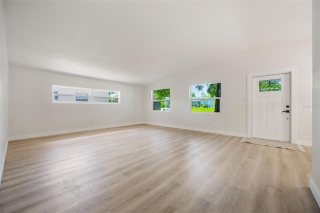 3813 Surrey Dr, Orlando, FL 32812 - foyer with light wood-style flooring, baseboards, and vaulted ceiling