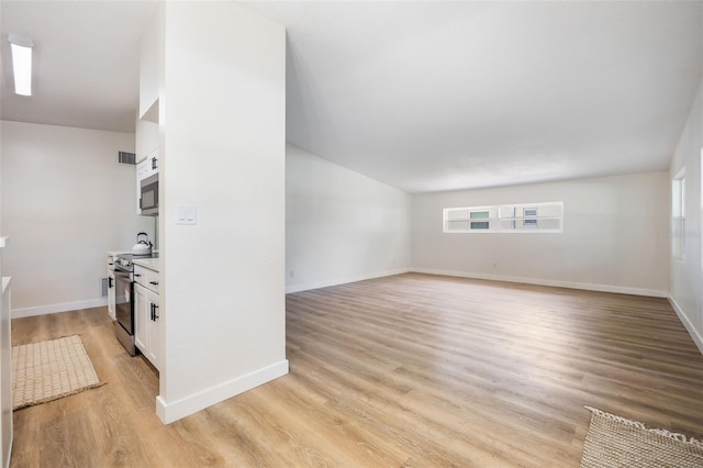 3813 Surrey Dr, Orlando, FL 32812 - unfurnished living room with light wood-type flooring and baseboards