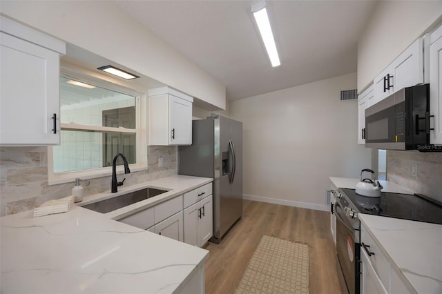 3813 Surrey Dr, Orlando, FL 32812 - kitchen featuring stainless steel appliances, a sink, light stone counters, and tasteful backsplash