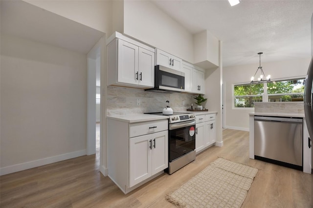 3813 Surrey Dr, Orlando, FL 32812 - kitchen featuring stainless steel appliances, tasteful backsplash, baseboards, and white cabinets