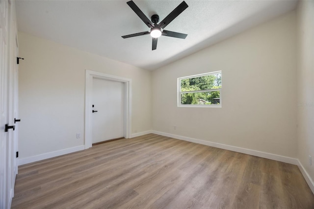 3813 Surrey Dr, Orlando, FL 32812 - spare room featuring a ceiling fan, vaulted ceiling, light wood-style floors, and baseboards