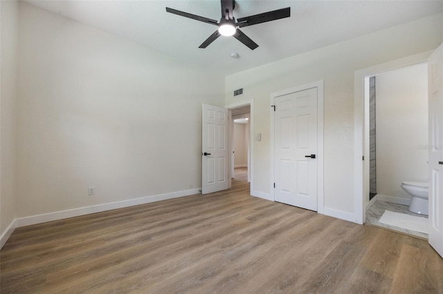 3813 Surrey Dr, Orlando, FL 32812 - unfurnished bedroom with light wood finished floors, ensuite bathroom, baseboards, lofted ceiling, and a ceiling fan