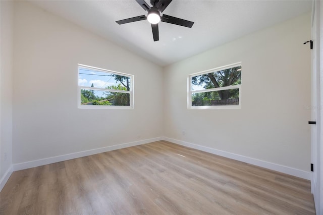 3813 Surrey Dr, Orlando, FL 32812 - unfurnished room with plenty of natural light, lofted ceiling, light wood finished floors, and baseboards
