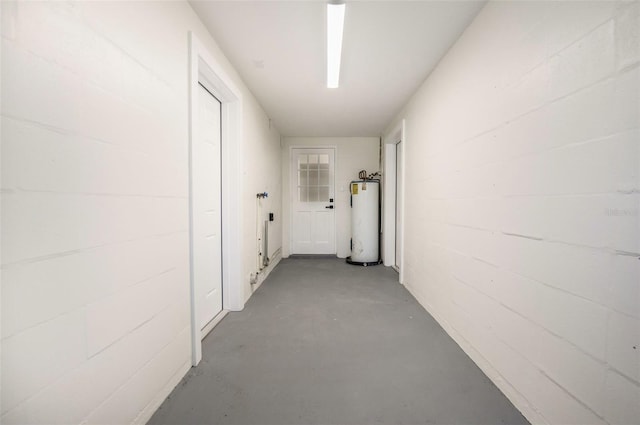 3813 Surrey Dr, Orlando, FL 32812 - corridor with water heater, finished concrete flooring, and concrete block wall