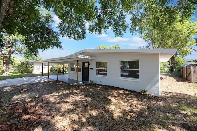 3813 Surrey Dr, Orlando, FL 32812 - view of front facade with an attached carport, a patio, and driveway