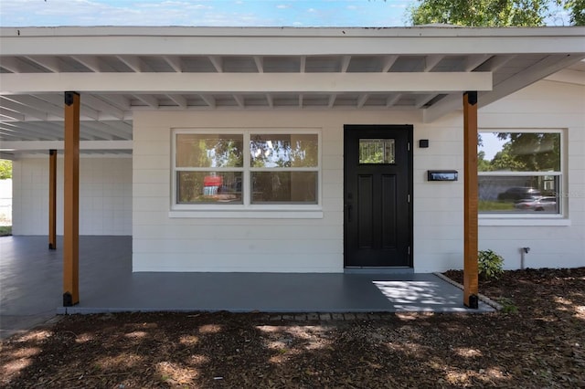 3813 Surrey Dr, Orlando, FL 32812 - doorway to property with an attached carport and covered porch