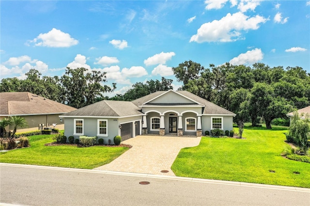 3176 Pearly Dr, Lakeland, FL 33812 - view of front of house with a garage, stucco siding, decorative driveway, and a front yard