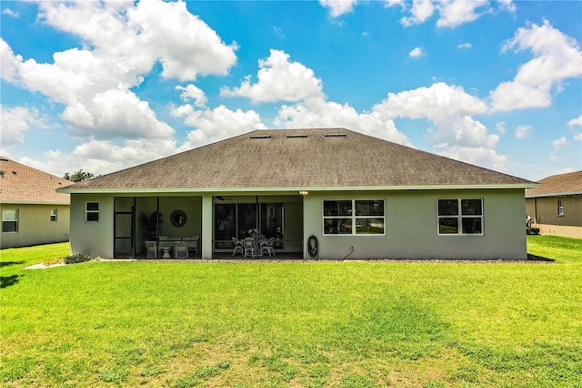 3176 Pearly Dr, Lakeland, FL 33812 - rear view of property featuring a yard, stucco siding, a shingled roof, and a sunroom