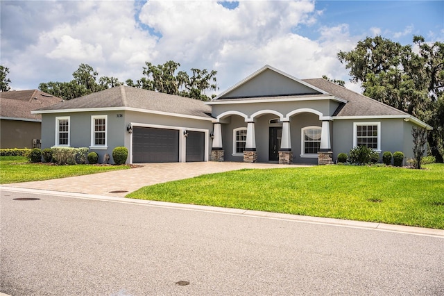 3176 Pearly Dr, Lakeland, FL 33812 - view of front of home with an attached garage, driveway, a front yard, stucco siding, and a porch