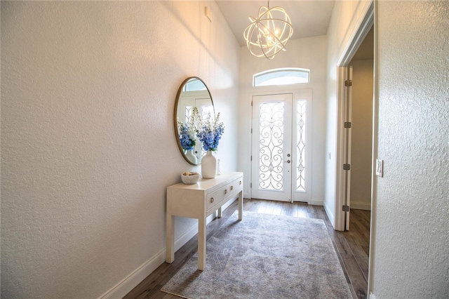 3176 Pearly Dr, Lakeland, FL 33812 - foyer entrance with a chandelier, wood finished floors, a textured wall, and baseboards