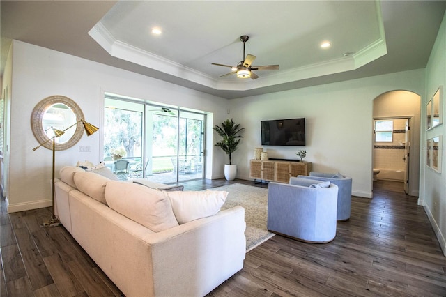 3176 Pearly Dr, Lakeland, FL 33812 - living area with a tray ceiling, crown molding, a ceiling fan, arched walkways, and dark wood-style floors