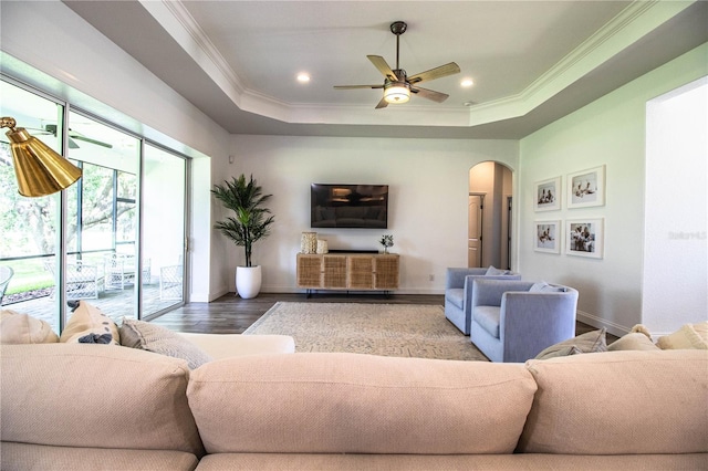 3176 Pearly Dr, Lakeland, FL 33812 - living room with arched walkways, wood finished floors, ceiling fan, baseboards, and ornamental molding