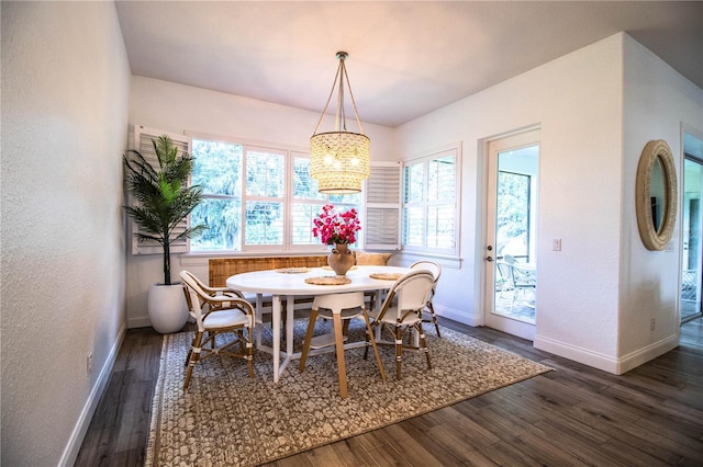 3176 Pearly Dr, Lakeland, FL 33812 - dining room with baseboards, dark wood-style flooring, a chandelier, and a textured wall