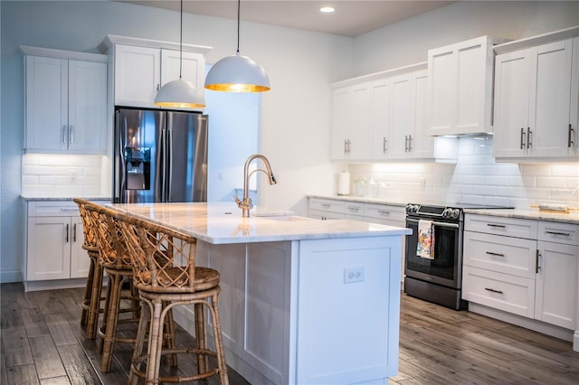 3176 Pearly Dr, Lakeland, FL 33812 - kitchen featuring refrigerator with ice dispenser, stainless steel range with electric cooktop, a kitchen breakfast bar, dark wood-style flooring, and recessed lighting