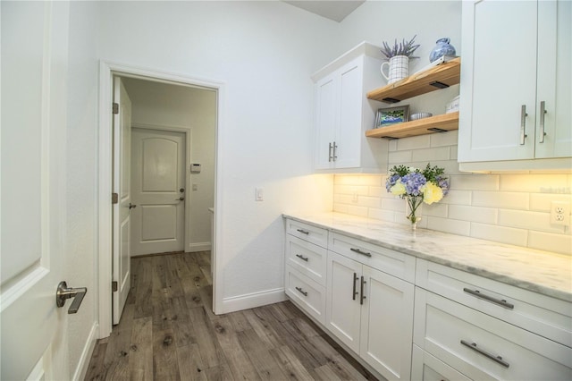 3176 Pearly Dr, Lakeland, FL 33812 - kitchen featuring backsplash, white cabinetry, open shelves, wood finished floors, and baseboards