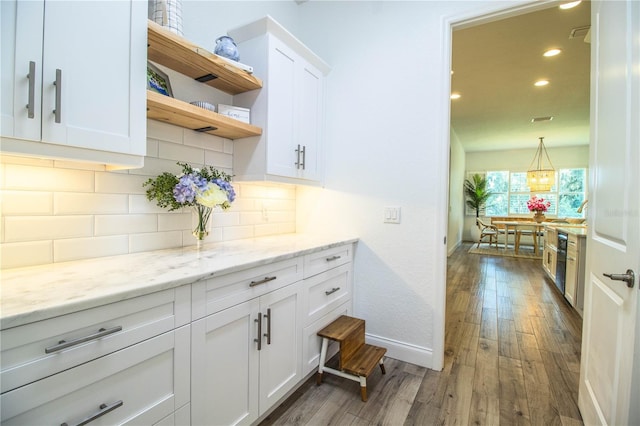3176 Pearly Dr, Lakeland, FL 33812 - bar with wood finished floors, backsplash, recessed lighting, and baseboards