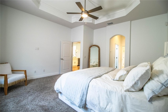 3176 Pearly Dr, Lakeland, FL 33812 - carpeted bedroom with a raised ceiling, arched walkways, ornamental molding, baseboards, and ceiling fan