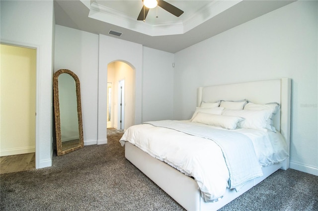 3176 Pearly Dr, Lakeland, FL 33812 - carpeted bedroom with a tray ceiling, arched walkways, ornamental molding, ceiling fan, and baseboards