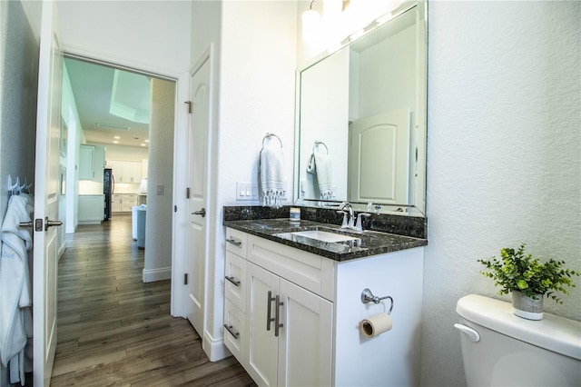 3176 Pearly Dr, Lakeland, FL 33812 - bathroom with a textured wall, wood finished floors, vanity, and toilet
