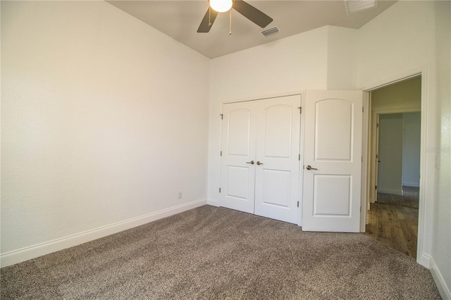 3176 Pearly Dr, Lakeland, FL 33812 - unfurnished bedroom with dark colored carpet, baseboards, a ceiling fan, and a closet
