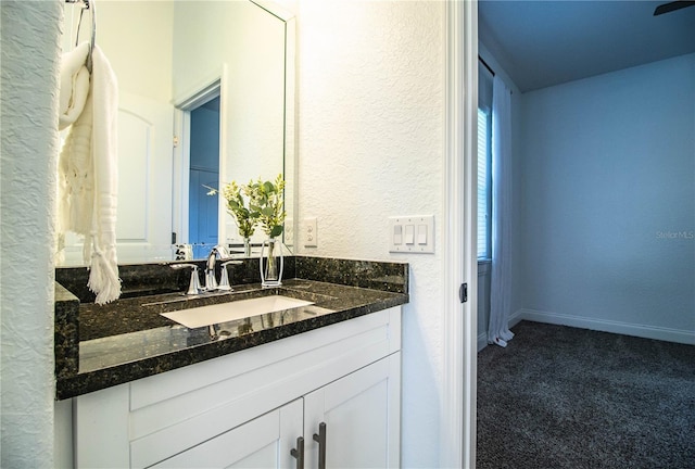 3176 Pearly Dr, Lakeland, FL 33812 - bathroom with a textured wall, vanity, and baseboards