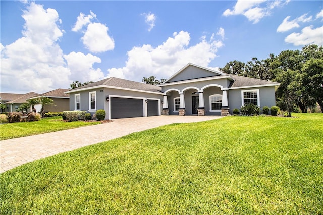 3176 Pearly Dr, Lakeland, FL 33812 - view of front of house featuring stucco siding, a garage, decorative driveway, and a front yard