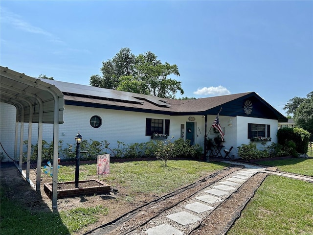 103 Inglis Way, Wauchula, FL 33873 - single story home featuring a front yard, solar panels, and brick siding