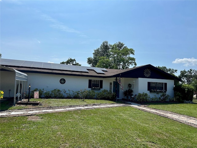 103 Inglis Way, Wauchula, FL 33873 - single story home with solar panels, a front lawn, and brick siding