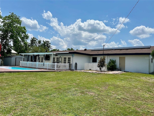 103 Inglis Way, Wauchula, FL 33873 - rear view of house with french doors, solar panels, and a yard