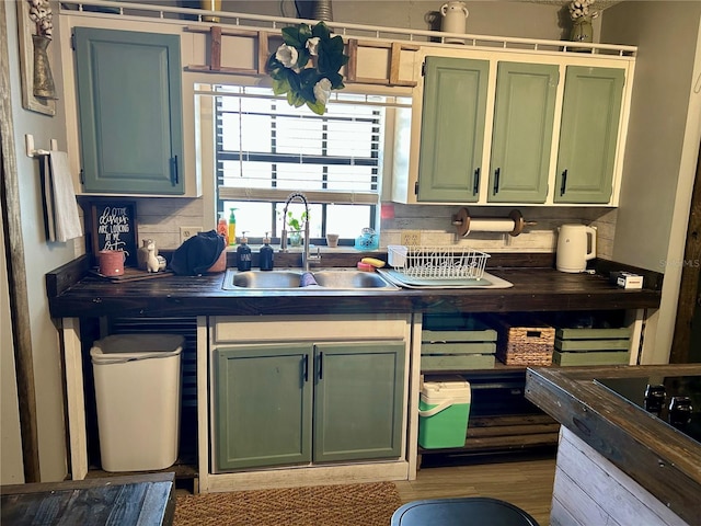 103 Inglis Way, Wauchula, FL 33873 - kitchen with a sink, green cabinetry, dark countertops, and wood finished floors