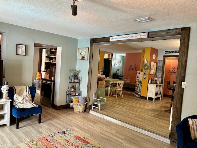 103 Inglis Way, Wauchula, FL 33873 - living area with wood finished floors, a textured ceiling, and baseboards