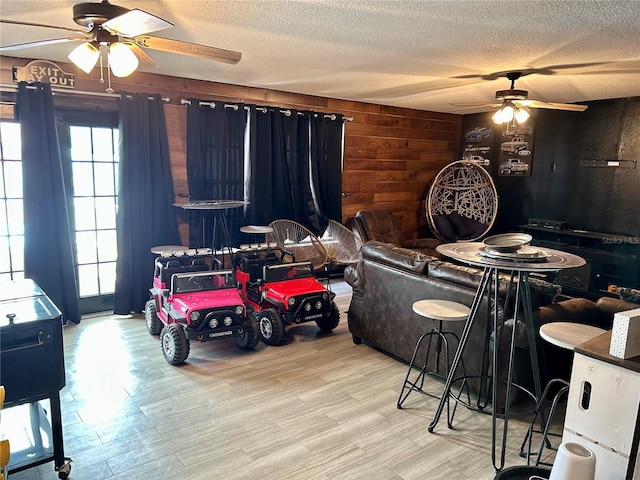 103 Inglis Way, Wauchula, FL 33873 - dining area with a ceiling fan, a textured ceiling, wood walls, and wood finished floors