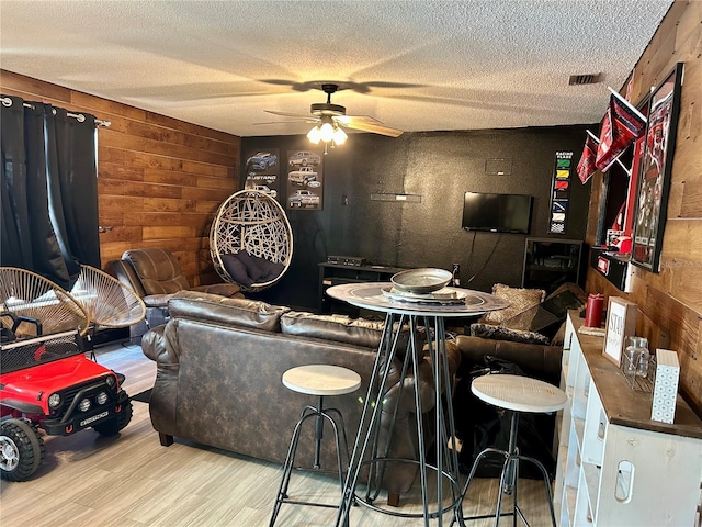 103 Inglis Way, Wauchula, FL 33873 - dining room featuring wooden walls, ceiling fan, a textured ceiling, and wood finished floors