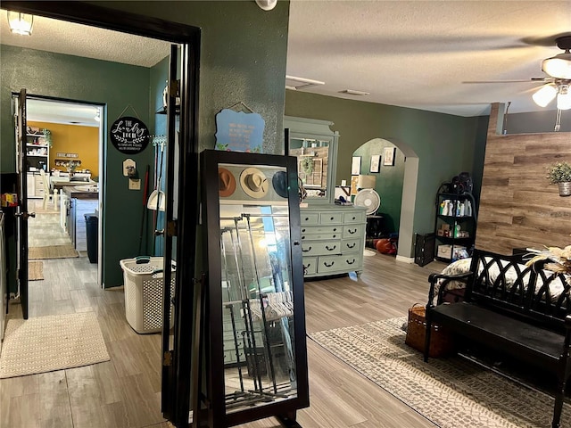 103 Inglis Way, Wauchula, FL 33873 - bedroom with arched walkways, a textured ceiling, wood finished floors, and a ceiling fan