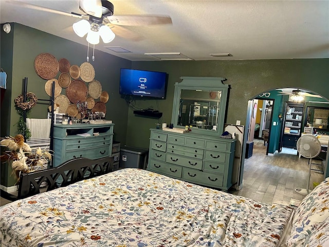 103 Inglis Way, Wauchula, FL 33873 - bedroom with wood finished floors, arched walkways, attic access, and ceiling fan