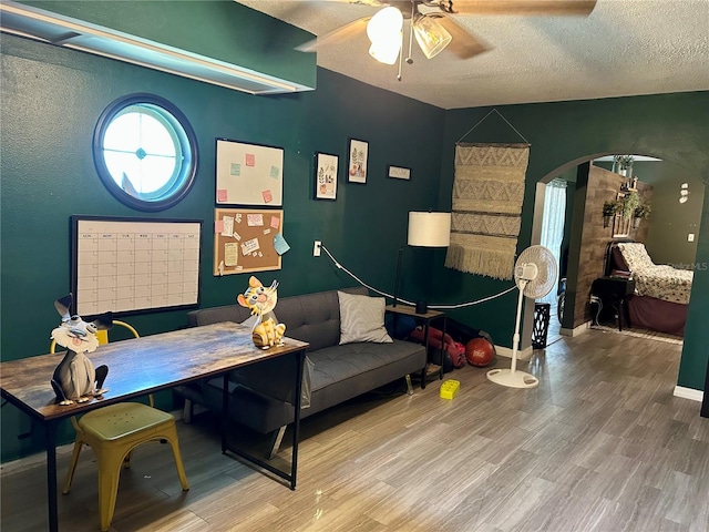 103 Inglis Way, Wauchula, FL 33873 - office space with ceiling fan, wood finished floors, arched walkways, a textured ceiling, and baseboards
