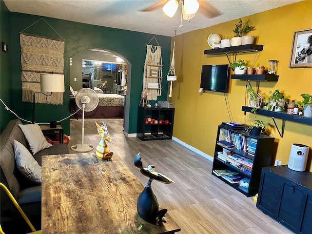 103 Inglis Way, Wauchula, FL 33873 - dining space with a ceiling fan, arched walkways, wood finished floors, a textured ceiling, and baseboards