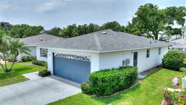 3618 Highland Fairways Blvd, Lakeland, FL 33810 - view of side of property with an attached garage, a shingled roof, a yard, and concrete driveway