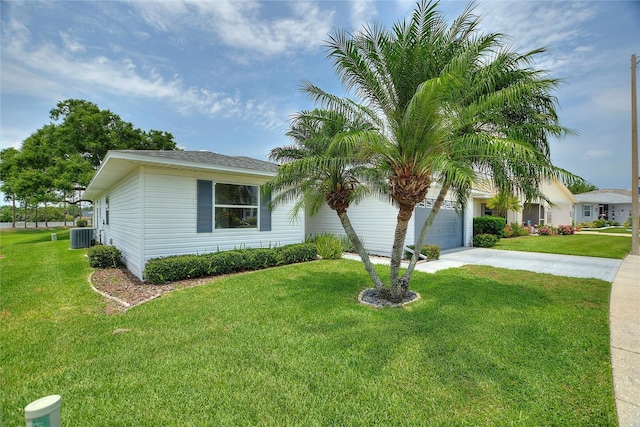 3618 Highland Fairways Blvd, Lakeland, FL 33810 - view of front facade with concrete driveway, a garage, a front yard, and central AC unit