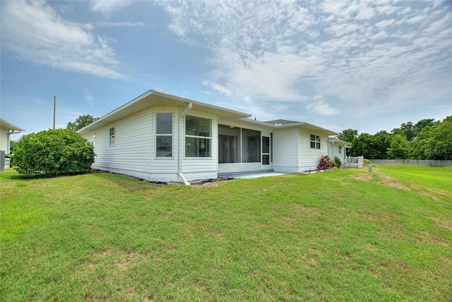 3618 Highland Fairways Blvd, Lakeland, FL 33810 - back of house with a lawn and a sunroom