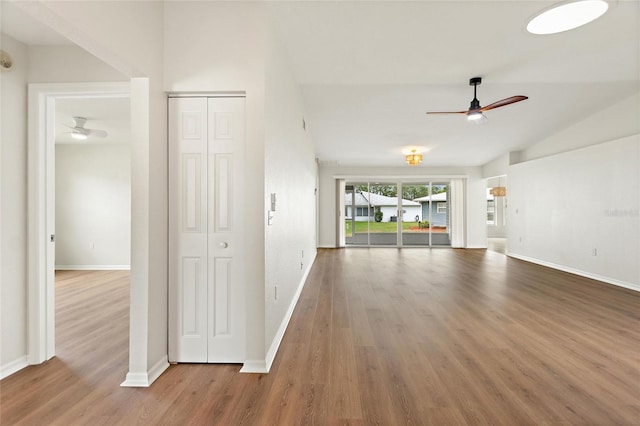 3618 Highland Fairways Blvd, Lakeland, FL 33810 - unfurnished living room featuring ceiling fan, wood finished floors, baseboards, and lofted ceiling