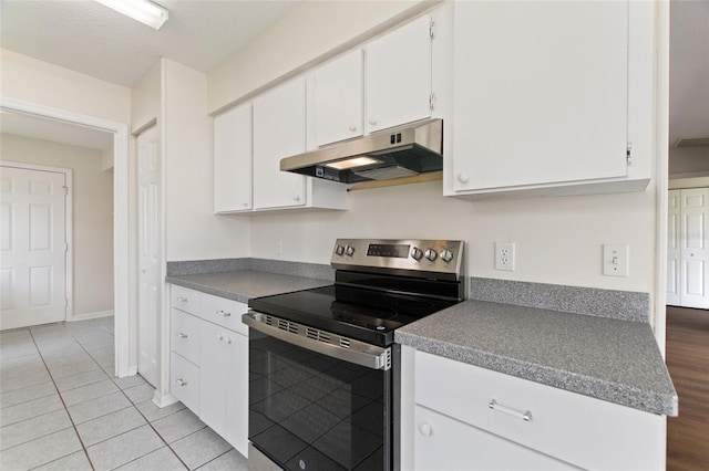 3618 Highland Fairways Blvd, Lakeland, FL 33810 - kitchen featuring stainless steel range with electric stovetop, under cabinet range hood, white cabinetry, and light tile patterned floors