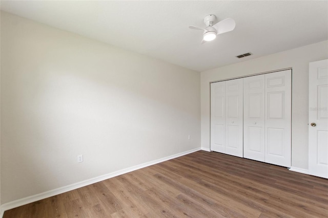 3618 Highland Fairways Blvd, Lakeland, FL 33810 - unfurnished bedroom with wood finished floors, baseboards, and a closet