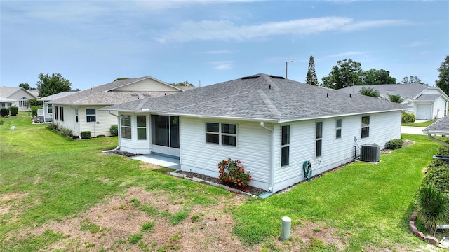 3618 Highland Fairways Blvd, Lakeland, FL 33810 - rear view of house featuring roof with shingles, central AC unit, a lawn, and a sunroom