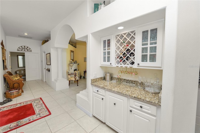 2936 Grasslands Dr, Lakeland, FL 33803 - indoor dry bar featuring ornate columns, arched walkways, light tile patterned flooring, and recessed lighting