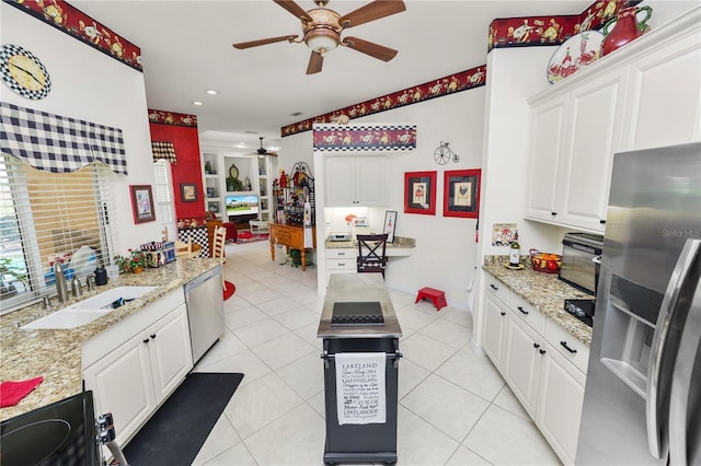 2936 Grasslands Dr, Lakeland, FL 33803 - kitchen featuring appliances with stainless steel finishes, a ceiling fan, white cabinets, light tile patterned floors, and recessed lighting