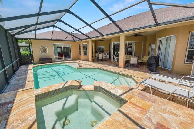 2936 Grasslands Dr, Lakeland, FL 33803 - view of swimming pool featuring ceiling fan, a patio, a pool with connected hot tub, and a lanai