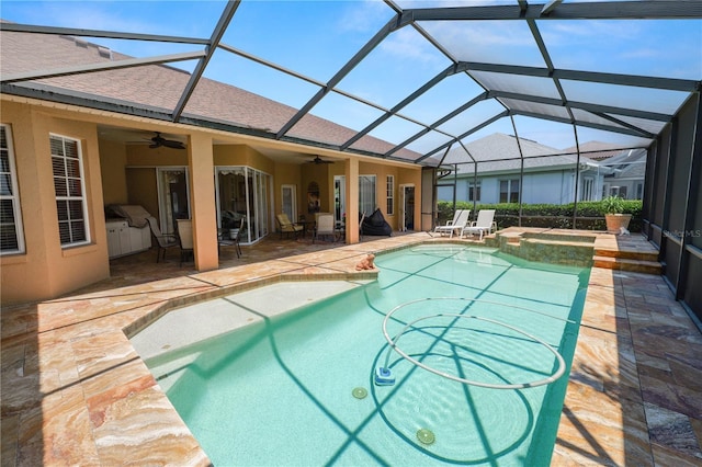 2936 Grasslands Dr, Lakeland, FL 33803 - view of swimming pool featuring ceiling fan, a patio, a pool with connected hot tub, and glass enclosure