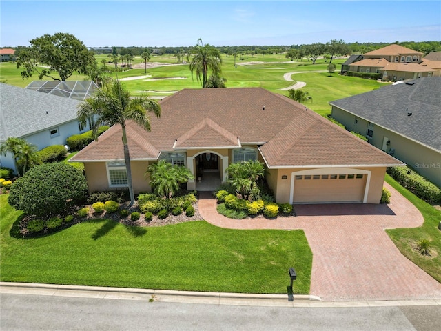 2936 Grasslands Dr, Lakeland, FL 33803 - view of front of house featuring a garage, decorative driveway, golf course view, and stucco siding